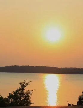 A bright sunset reflection on a Texas lake in July. Stock Photos