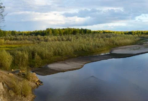 Bright sunset with reflection in water clouds a small river Kempendyay in Yak Stock Photos