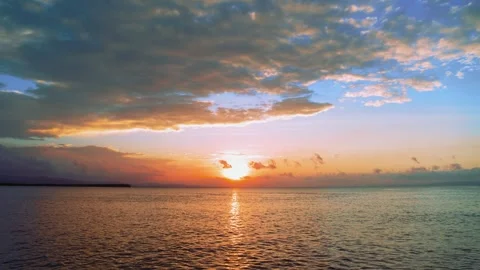Bright sunset sky with clouds over the ocean. Sunset orange over the sea horizon Stock Footage 244634218