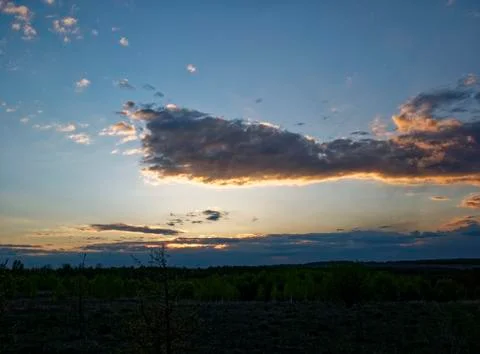 Bright sunset in spring through the clouds Stock Photos
