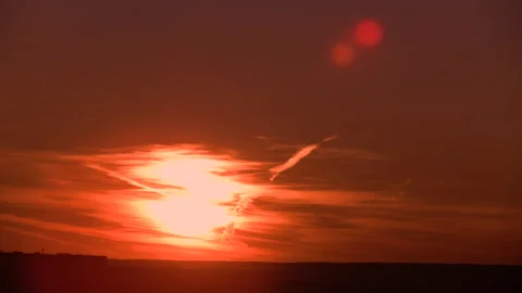 Bright sunset. The sun sets behind feather clouds. Time lapse. Stock Footage 142082173