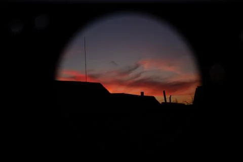Bright sunset through a round hole Photos