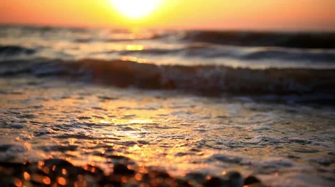 Bright sunset under the sea with waves splashes, fly spray and beautifully Stock Footage 47631234