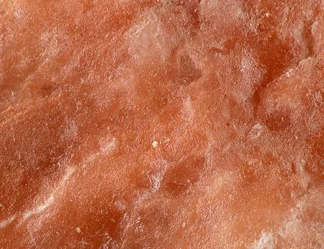 Bright surface texture of Himalayan salt block macro shot Stock Photos