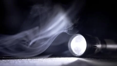 Bright Tactical Flashlight Beam Cutting Through Swirling Smoke On Dark Ground Stock Footage 330114509