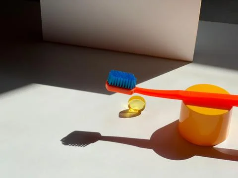 Bright toothbrush with bright objects. Still life. Dental care. Morning routine Stock Photos
