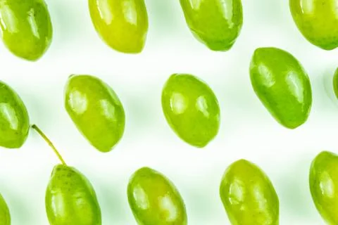 Bright top view pattern of fresh green olives on white background Stock Photos