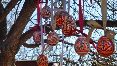 Bright traditional Ukrainian Easter eggs hanging on ribbons with bows 스톡 동영상 332349345