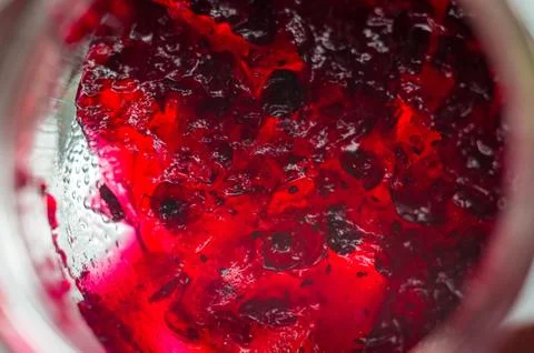 Bright translucent red currant jam in a glass jar Stock Photos