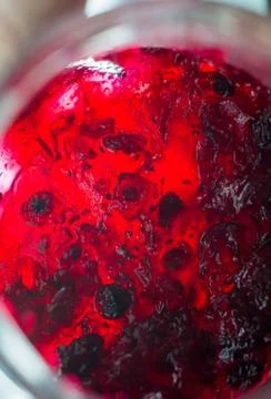 Bright translucent red currant jam in a glass jar Stock Photos