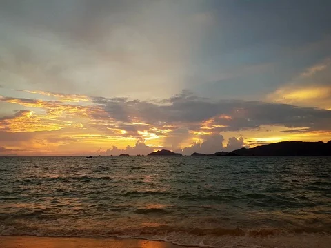 Bright tropical sunset sun rays above the dark sea Stock Footage 80985291