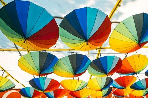 Bright umbrellas of various colors create  hanging decoration over market. sc Stock Photos