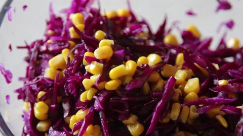Bright vegetables in a salad. Red cabbage and corn. Healthy vegetarian food. Stock Footage 148500660