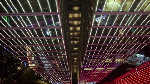 Bright vertical facade lines above a night shopping complex at Dongguan CBD Stock Footage 346753222