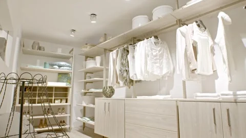 Bright Walk In Closet With White Blouses and Shoe Rack, Interior Pan Shot Stock-Footage 341395425