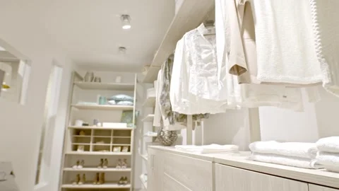 Bright Walk in Closet with White Clothes and Shelves, Dressing Room, Slow Pan Stock Footage 341395095