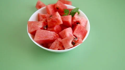 Bright watermelon cubes with green mint leaf in bowl Stock Footage 320003784
