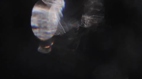 Bright white bokeh lights appear in the black. Vidéo 318774476