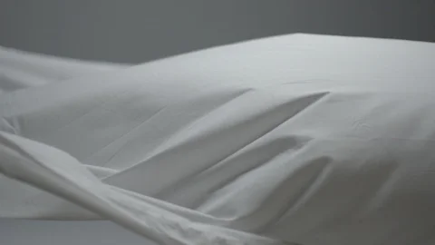 Bright white cloth on a medium gray backgroubd Stock Footage 87766022