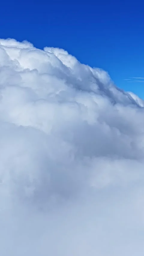 Bright White Cloud Tops Beneath Deep Blue Sky Vertical Aerial Background 스톡 동영상 336781272