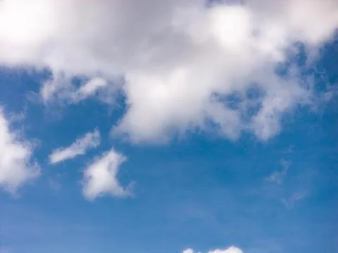 Bright White Clouds Above a Wide Blue Sky Opening Stock Photos