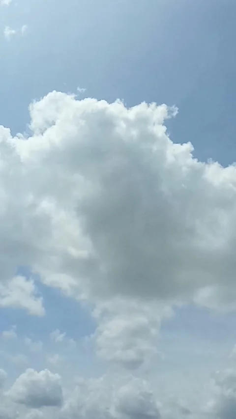 Bright white clouds fly across the bright blue sky. The sky is clear in the.. Stock Footage 267335732