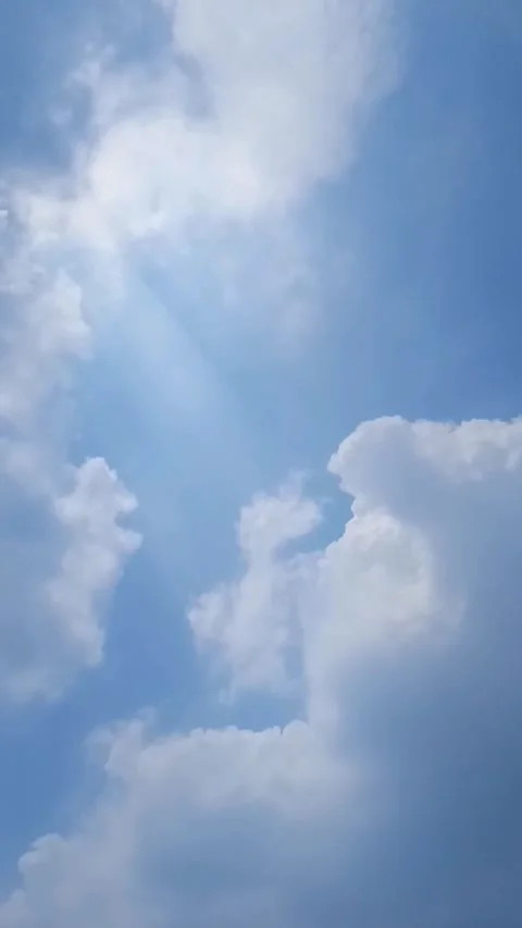 Bright white clouds flying fast across the clear blue sky. Clear sky in the dayt Stock Footage 287215492
