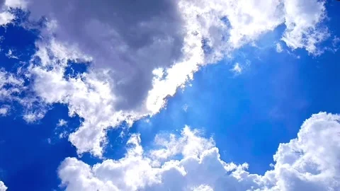 Bright White Clouds Moving Across Blue Sky in Daylight Stock Footage 328486318