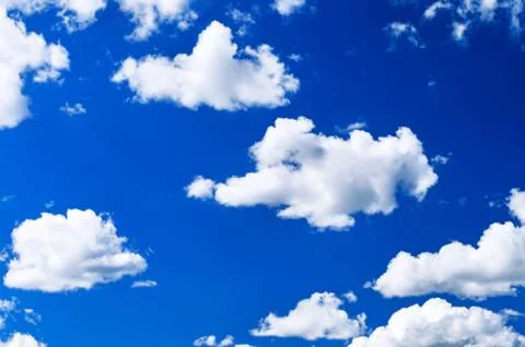 Bright White Cumulus Clouds in the Clear Blue Sky on a Summer Day. Stock Photos