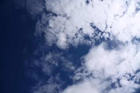Bright white cumulus clouds in a deep blue sky Stock Photos