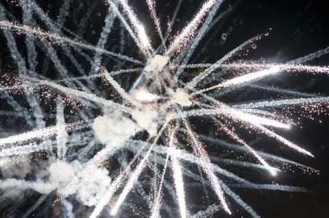 Bright white fireworks exploding in the night sky 스톡 사진