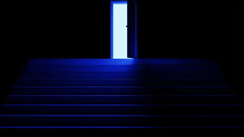 A bright white light appears in a dark room with steps after opening the  door. Stock Footage 253263439
