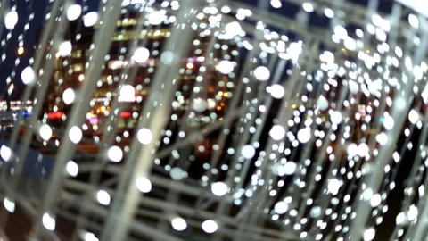 Bright white lights out of focus flashing against a decorated street. Stock Footage 167003750