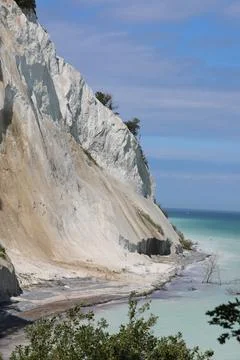 Bright white limestone cliff is being eroded by natural elements overlookin.. Stock Photos