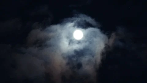 Bright white moon between gray volume cumulus clouds. Divination time. Stock Footage 108023739