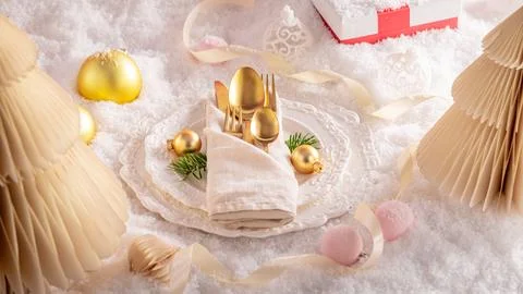Bright white table arranged with festive decor. Stock Photos