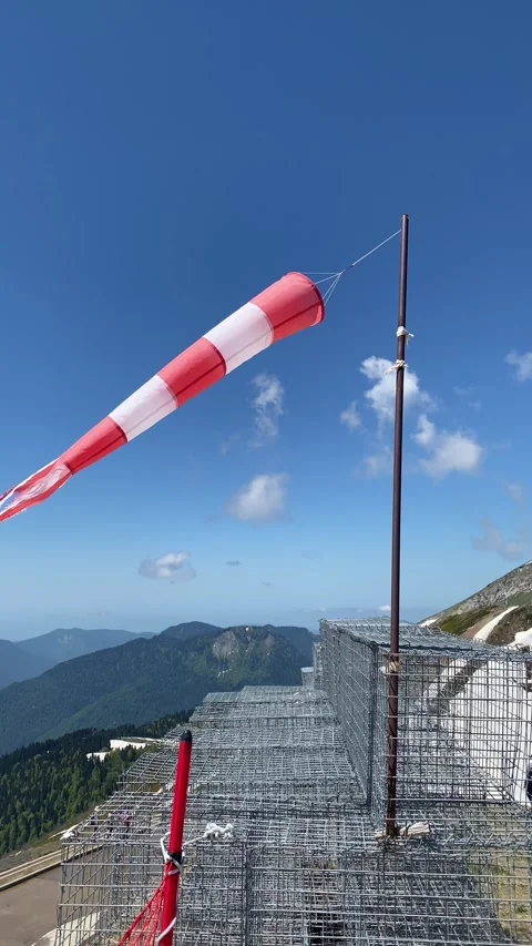 Bright windsock cone stands at highest point of mountain Stock Footage 278021432