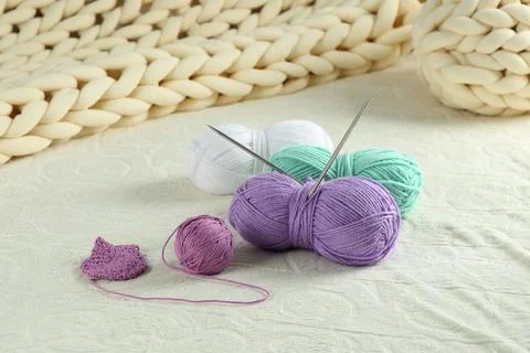 Bright yarns, pattern sample and knitting needles on soft blanket Stock Photos
