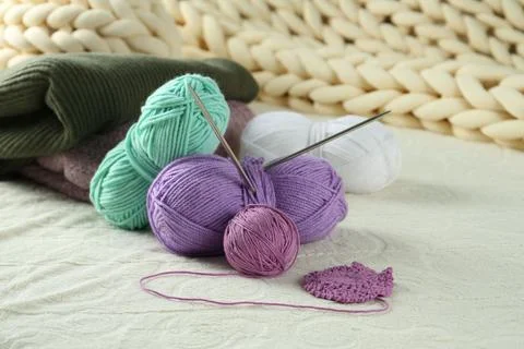 Bright yarns, pattern sample and knitting needles on soft blanket 스톡 사진