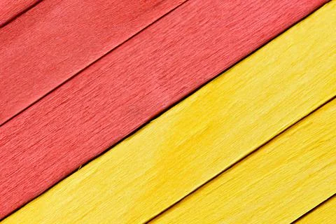 Bright yellow and red painted boards arranged diagonally. Stock Photos