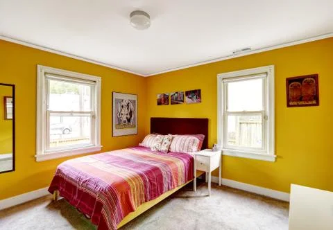 Bright yellow bedroom interior Stock Photos