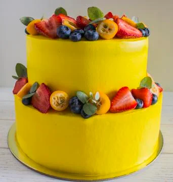 Bright yellow cale with berries and fruits Stock Photos