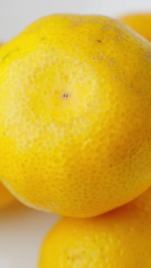 Bright yellow citrus fruit surface with vibrant textures shot in a rotating Stock Footage 293527524
