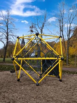A bright yellow climbing structure at a playground in an autumn park 스톡 사진