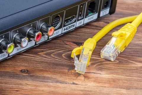 Bright yellow Ethernet network LAN cables with RJ45 connectors lying near a d Stock Photos