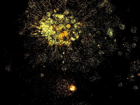Bright yellow fireworks exploding in the night sky during a celebration. Foto stock