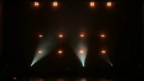 Bright yellow lights alternately light up and go out on stage in the dark. Stock Footage 105352393