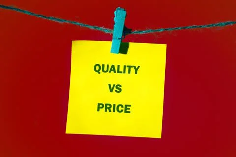 Bright yellow note featuring text regarding quality and price hangs on a simp Stock Photos