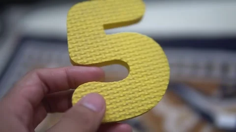 A bright yellow number five Stock Footage 300426928