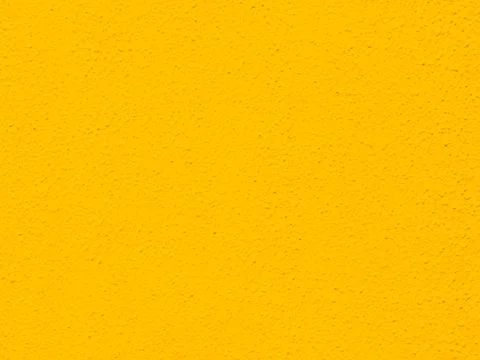 Bright yellow painted rough textured wall background photograph. Stock Photos